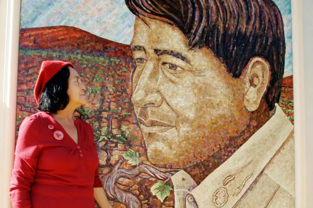 United Farm Workers co-founder Dolores Huerta looks at a mural...