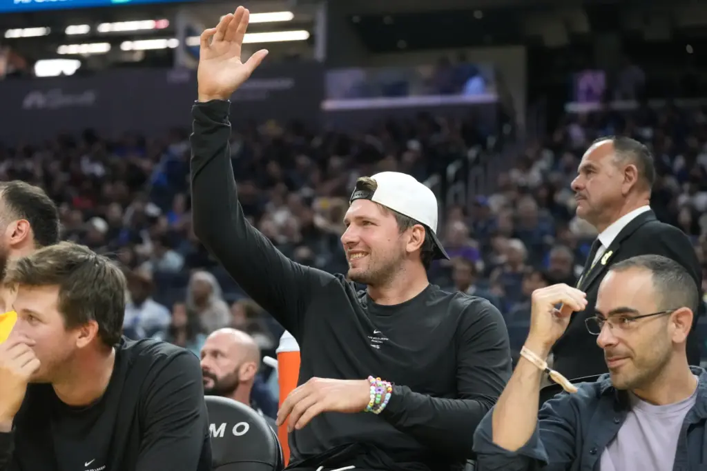 Lakers star Luka Doncic, middle, gestures from the bench during...
