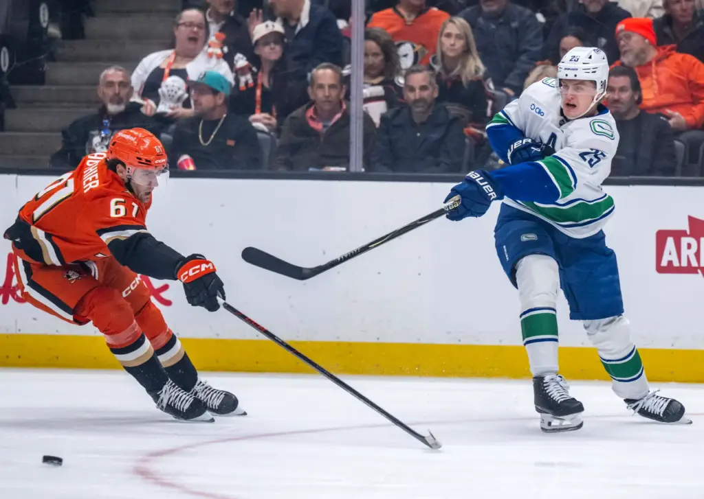 The Vancouver Canucksâ Elias Pettersson, right, takes a shot on...