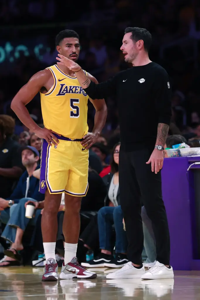 Lakers head coach JJ Redick talks to guard Quentin Grimes...