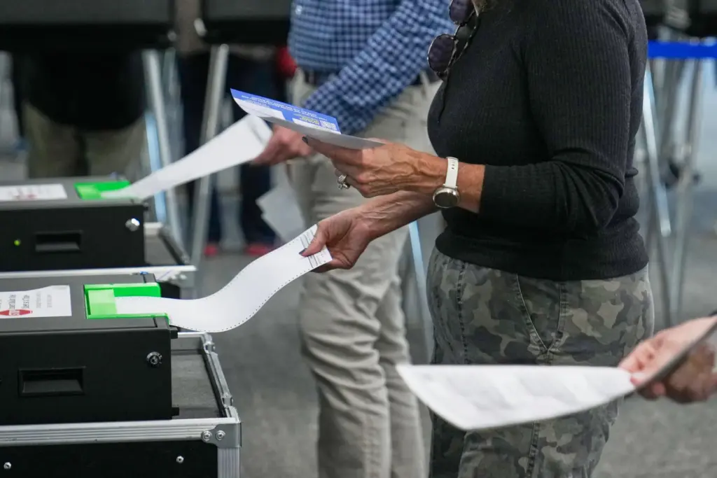 Voters enter their ballots into scanners at early in-person voting in Cleveland.