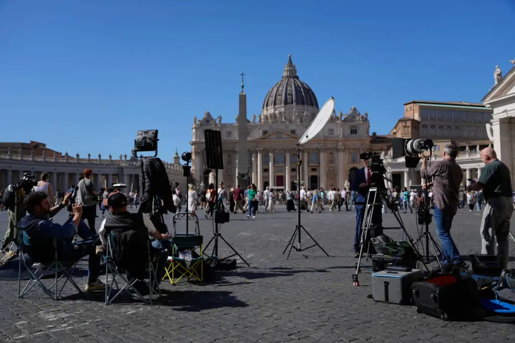A TV news crew stands outside St. Peter's Square, in Rome.