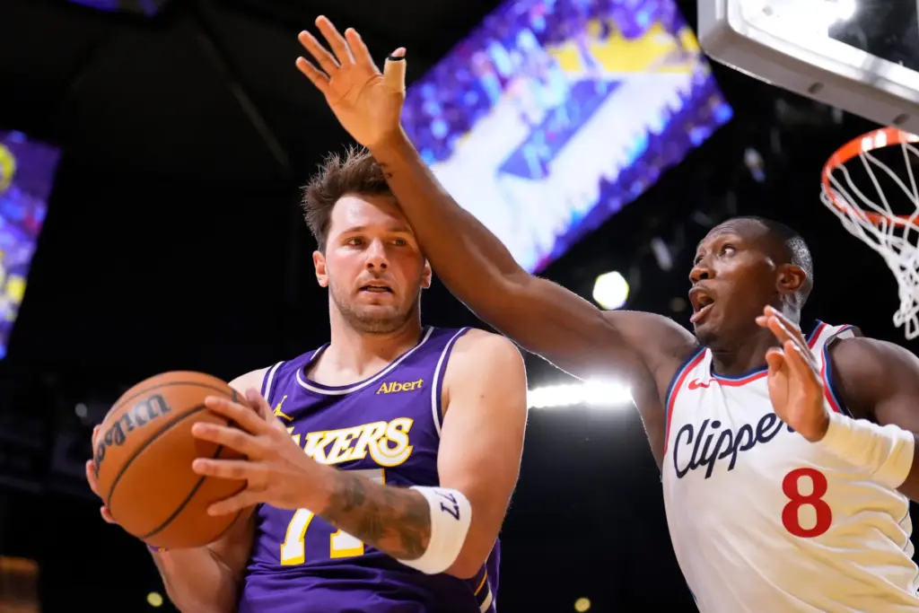 Lakers guard Luka Doncic, left, tries to make a move...