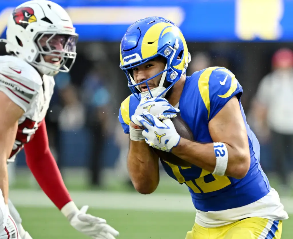 Rams wide receiver Puka Nacua (12) holds onto the ball...
