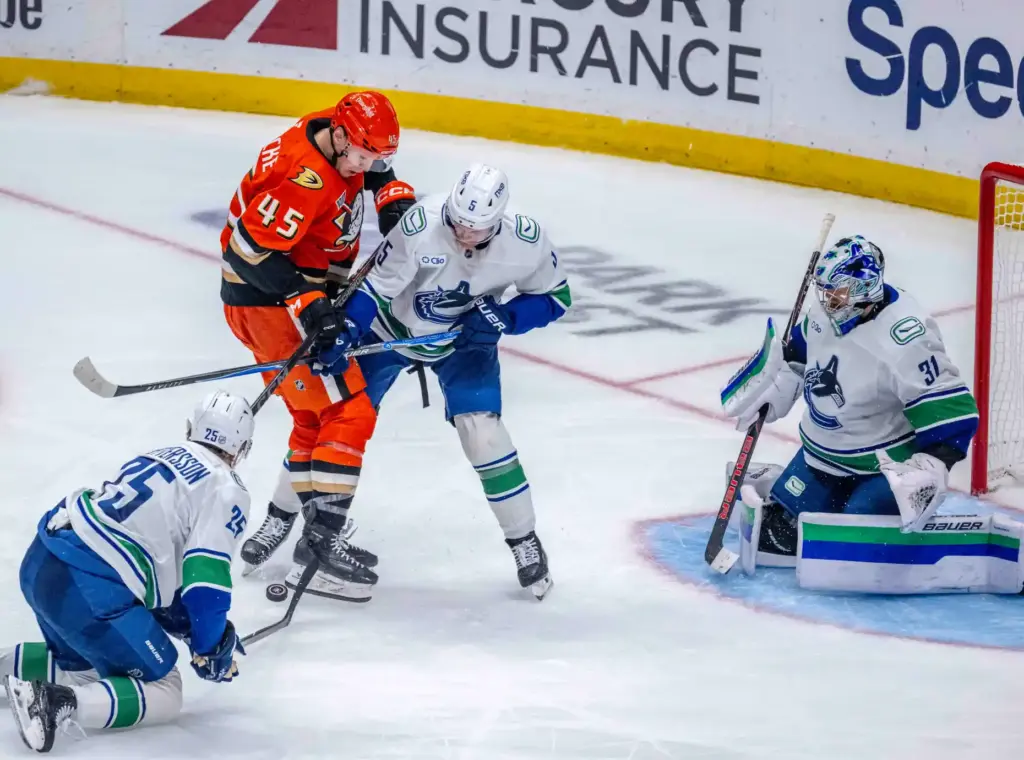 The Ducksâ Beckett Sennecke (45) tries to kick the puck...