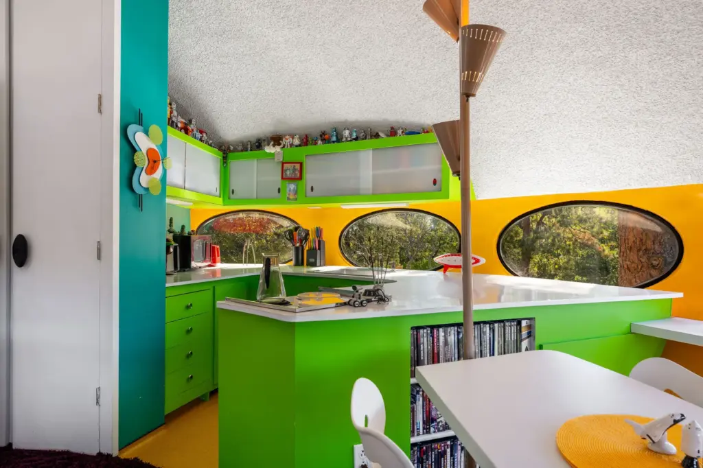 The compact, lime-green kitchen features custom cabinetry. (Photo by Cesar...