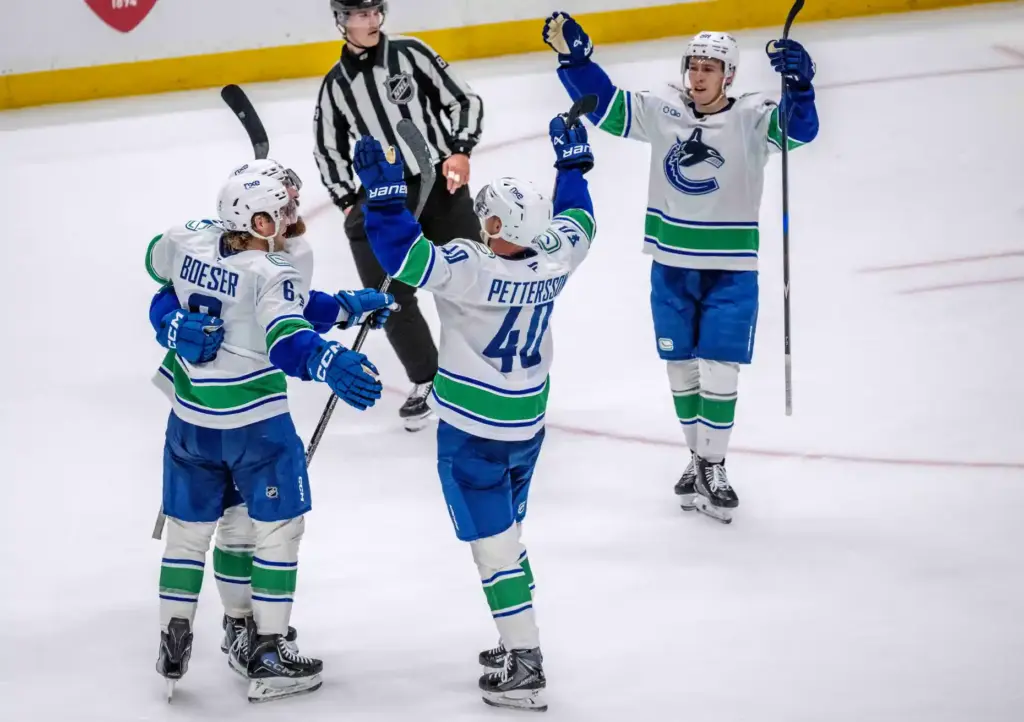 Vancouver Canucks players, including Brock Boeser (6) and Elias Pettersson...