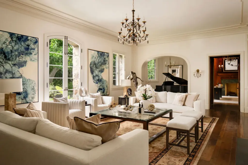 The living room features a niche for a baby grand...