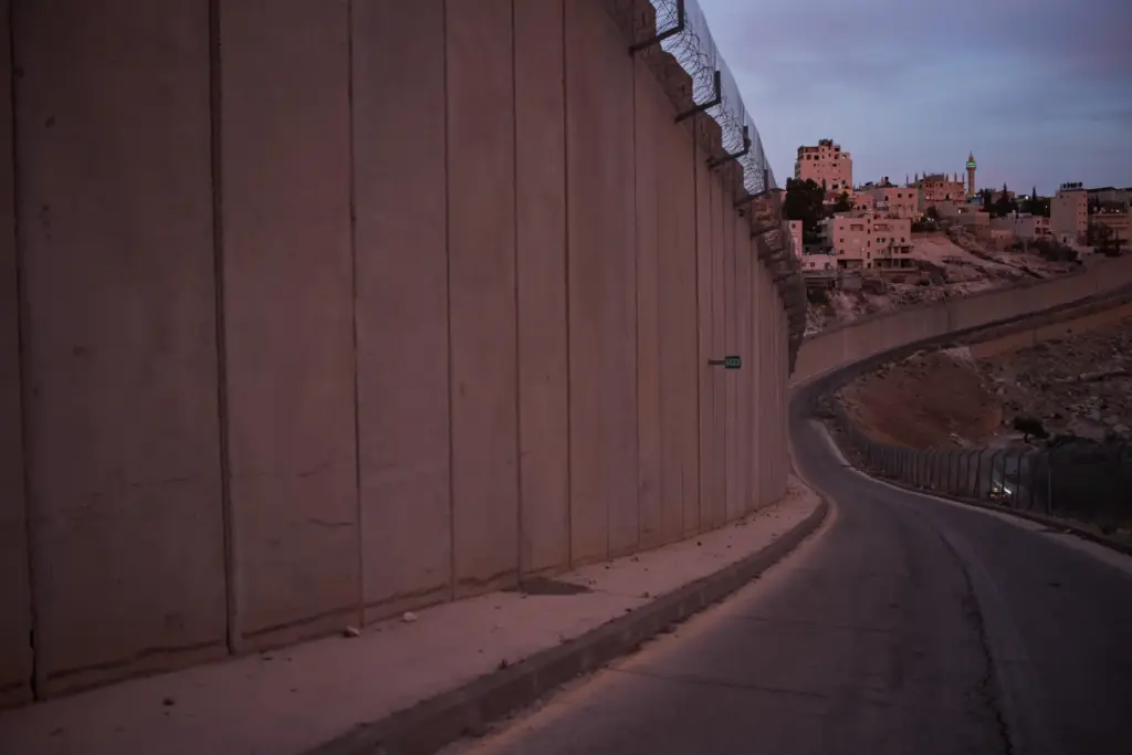 A mosque's minaret and buildings are seen in the West Bank village of Abu Dis.