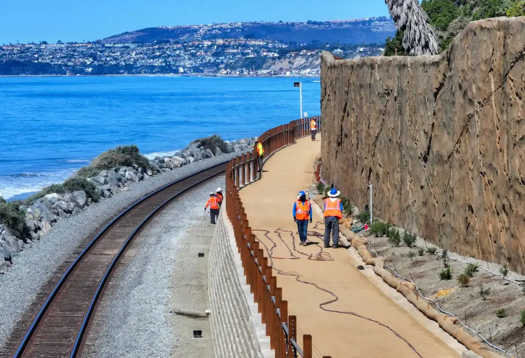 Workers put the finishing touches on the beach trail north...