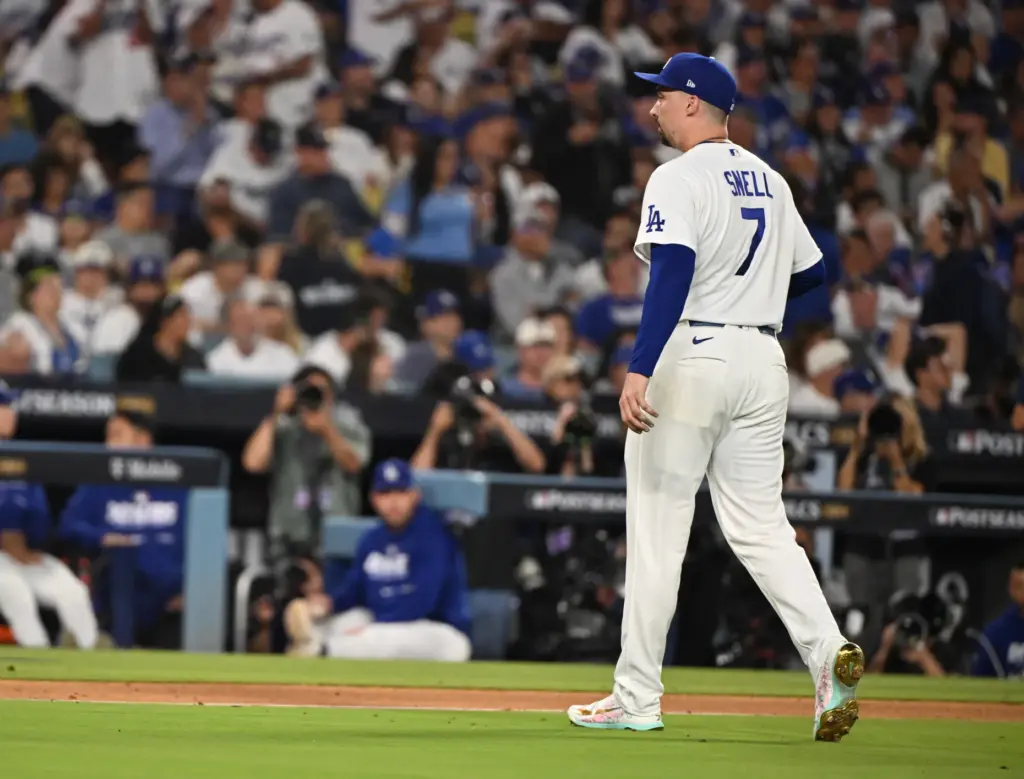 Dodgers starting pitcher Blake Snell walks off the field after...