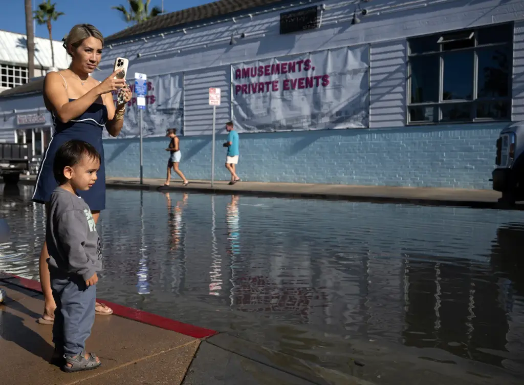 Christina Cao stopped to see the Balboa Fun Zone flooding...