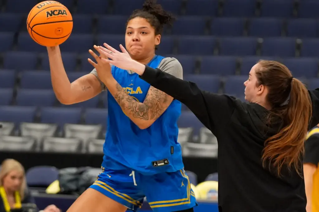 UCLA forward Timea Gardiner, left, passes the ball during practice...