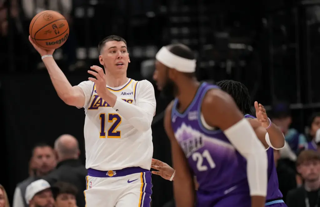 Lakers forward Jake LaRavia (12) passes the ball against the...