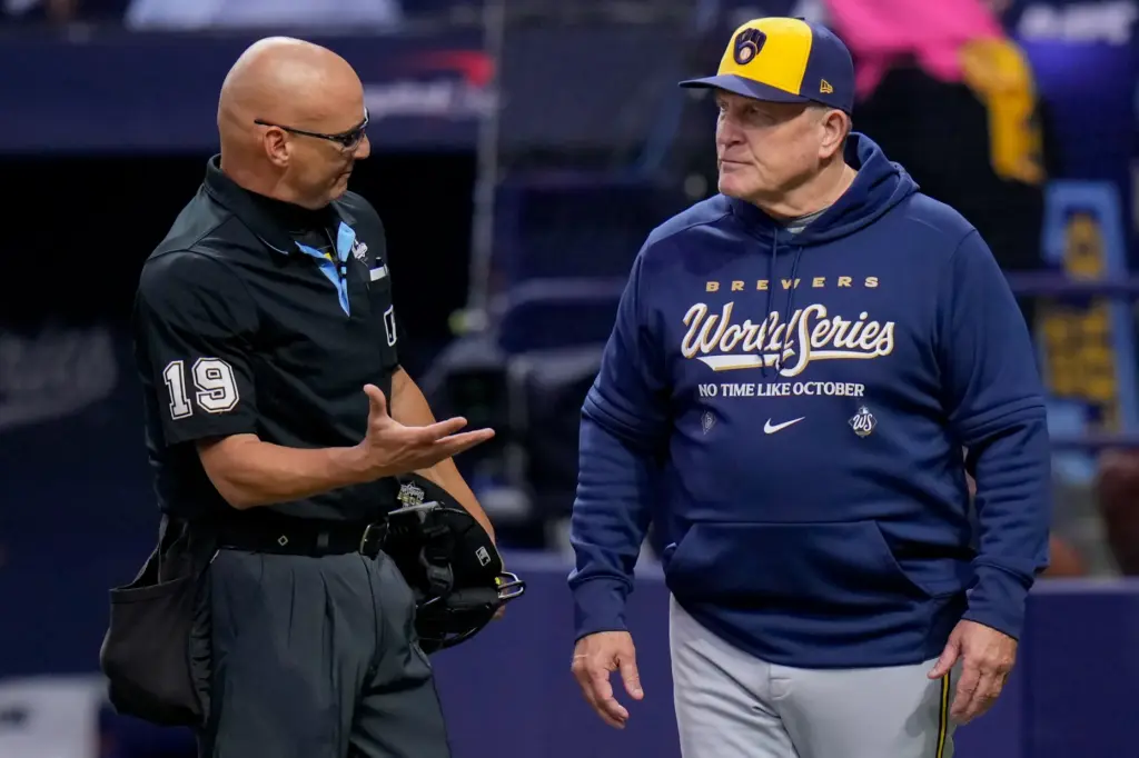 Milwaukee Brewers manager Pat Murphy talks with home plate umpire...