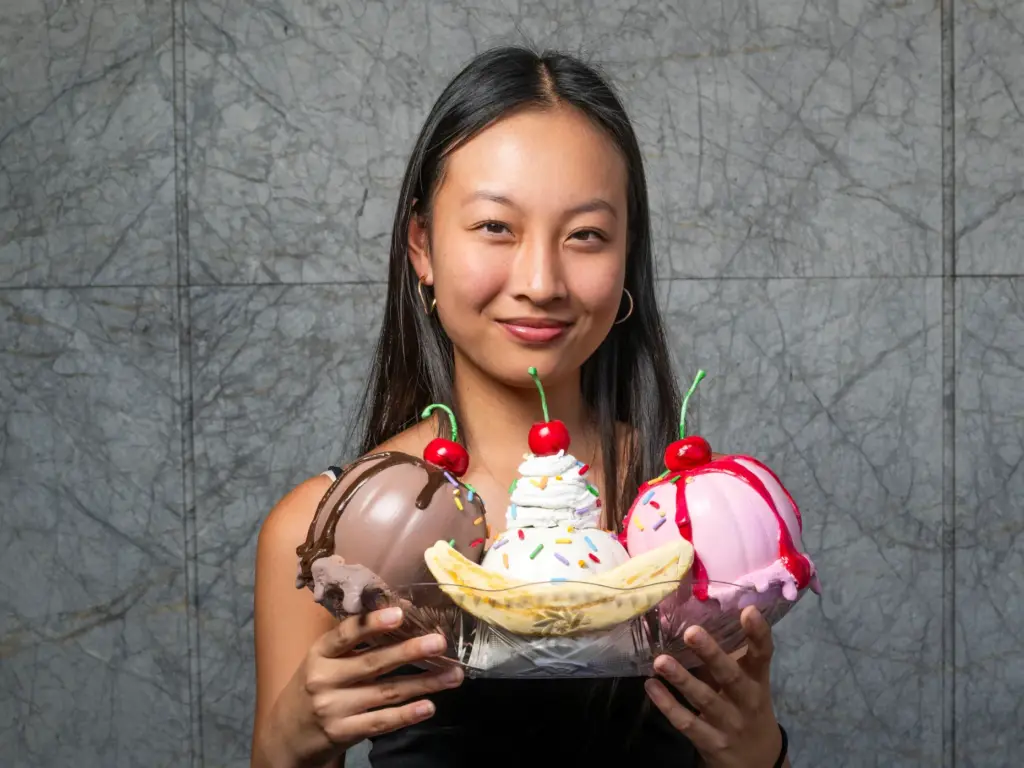 Sarah Hsu holds her pumpkin titled âBanana Split Pumpkinsâ which...