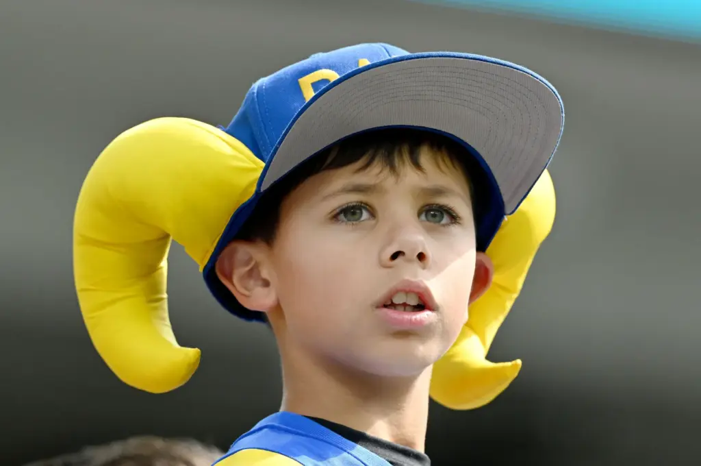 A young Rams fans watches as player warmup before the...