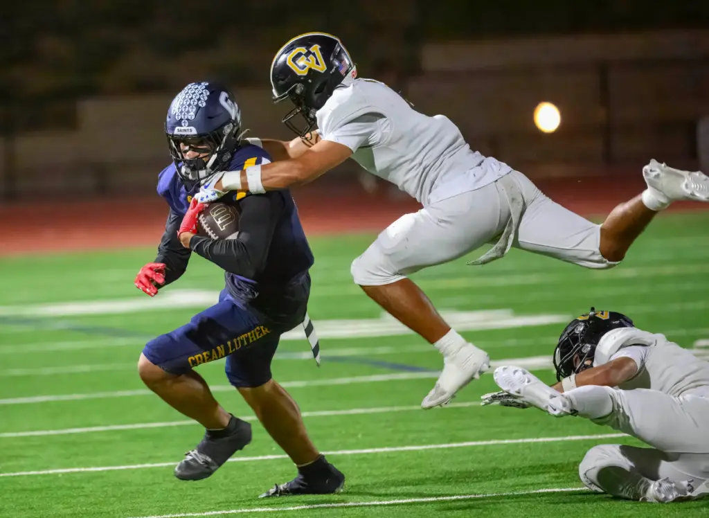 Capistrano Valleyâs Jolan Gonzalez, right, jumps on Crean Lutheran wide...