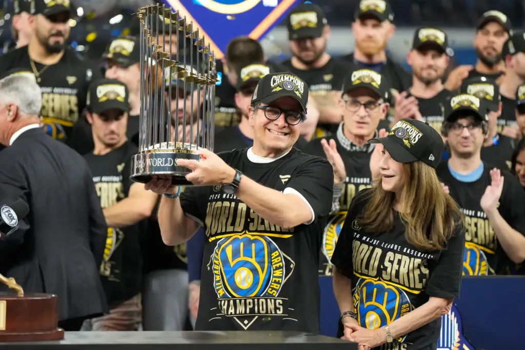 Milwaukee Brewers owner Mark Attanasio celebrates with the trophy after...