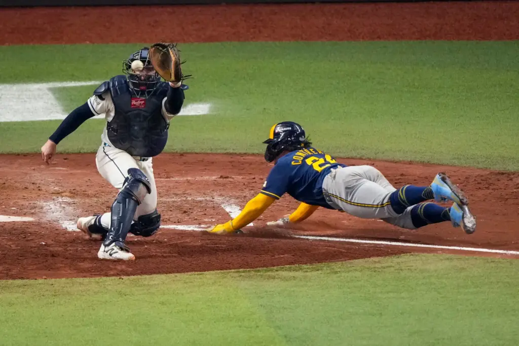 The Milwaukee Brewers’ William Contreras scores on a sacrifice fly...
