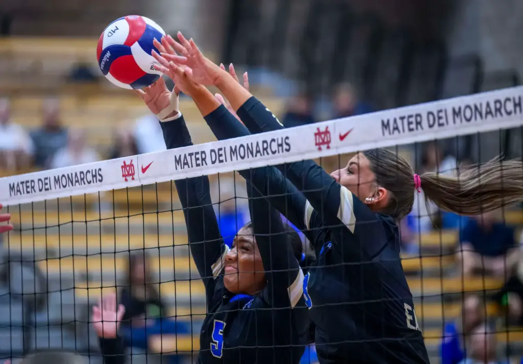 Santa Margarita’s Ella Opene, left, and Katherine Jackson jump to...