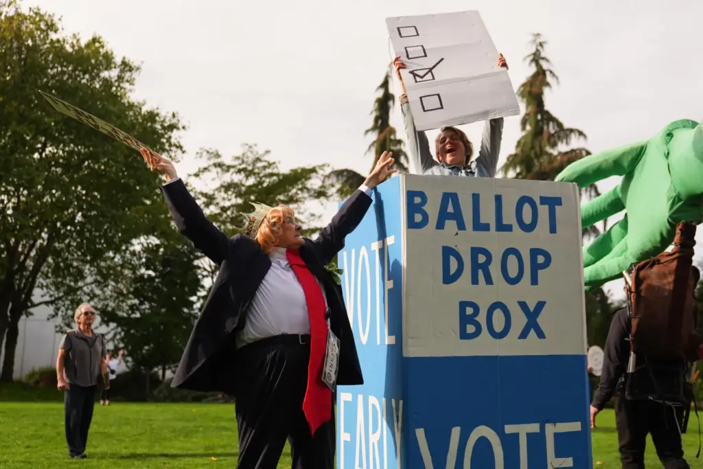 Dressed as President Donald Trump, Victoria Millard tries to stop Jessica Jones from submitting a ballot.