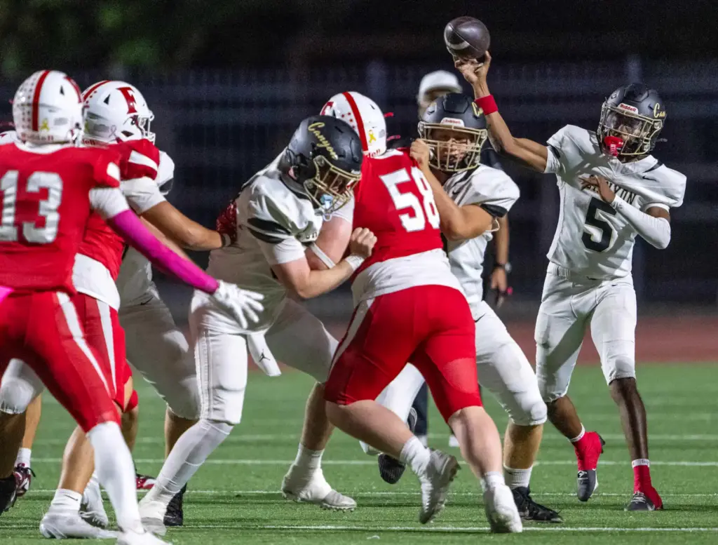 Canyon quarterback Kayden Phillips (5) throws the ball during a...