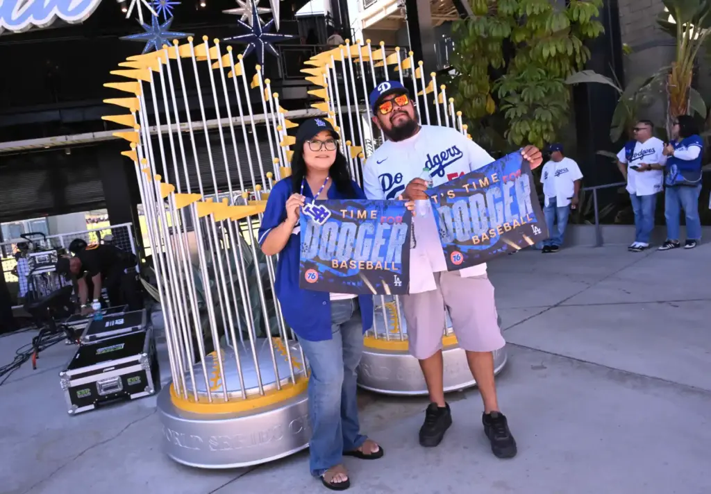 Fans pose for pictures with the oversized World Series trophy...