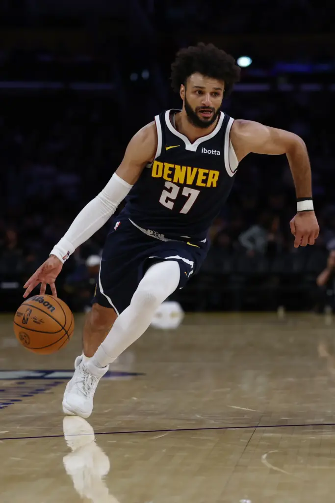 Denver Nuggets guard Jamal Murray brings the ball up the...